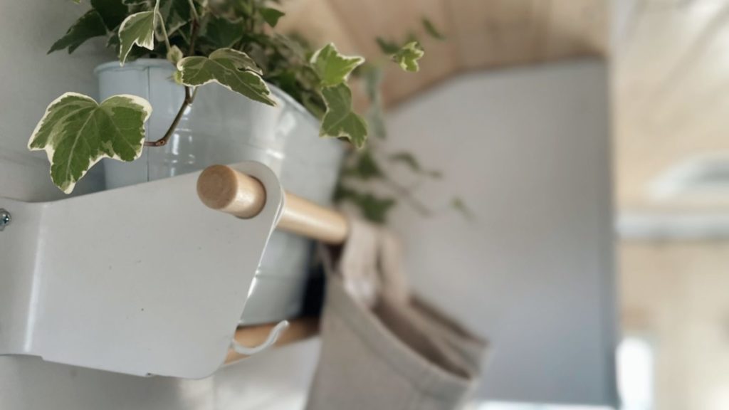 Shelf with plants. Finishing touches to build a campervan.
