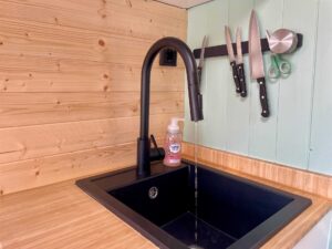 Close-up of a camper faucet dispensing running water